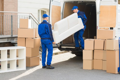 Boxes and furniture being loaded into a removals van