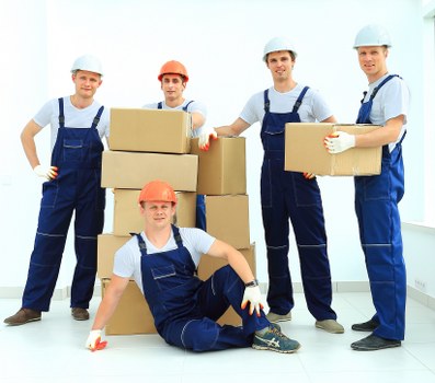 Mover carrying furniture for a Swiss Cottage home relocation