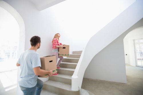 Removal professionals loading business items for transport in Swiss Cottage
