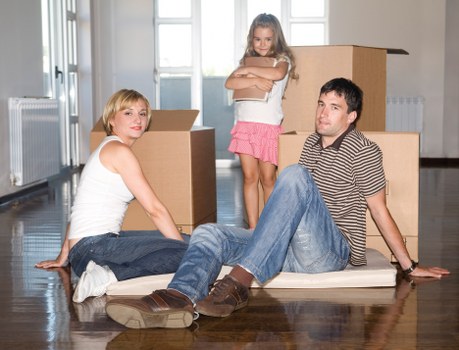 Movers carrying furniture in a flat with stair access in Swiss Cottage